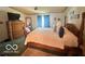 This bedroom boasts a wooden four-poster bed with a soft comforter and a matching dresser at 4726 Breckenridge Dr, Columbus, IN 47203