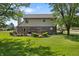 Spacious backyard with a large deck, lush lawn, and mature trees providing shade and privacy at 500 Meadowlark Ct, Whiteland, IN 46184