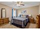 Comfortable bedroom featuring a ceiling fan, ample natural light, and classic wood furniture at 500 Meadowlark Ct, Whiteland, IN 46184