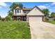 Two-story home featuring a two-car garage, well-maintained lawn, and charming curb appeal at 500 Meadowlark Ct, Whiteland, IN 46184