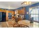 Cozy kitchen featuring wood cabinets, stainless steel appliances, and a granite-topped breakfast table at 500 Meadowlark Ct, Whiteland, IN 46184