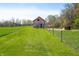 Picturesque barn on a grassy field, complemented by wooden fences and mature trees at 5079 S Lick Creek Rd, Morgantown, IN 46160