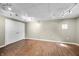 Finished basement with ample space, wood-look flooring, and well-lit by track lighting at 5079 S Lick Creek Rd, Morgantown, IN 46160