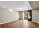Finished basement with wood-look flooring and a sliding door with access to the outside at 5079 S Lick Creek Rd, Morgantown, IN 46160