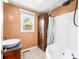 Bathroom featuring a soaking tub, cabinet for storage, and a stylish sink and mirror at 5079 S Lick Creek Rd, Morgantown, IN 46160