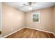 A cozy bedroom with hardwood floors, a ceiling fan, and a window that lets in natural light at 5079 S Lick Creek Rd, Morgantown, IN 46160