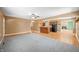 Open-concept living area with gray carpet and wood floors, seamlessly connected to the kitchen at 5079 S Lick Creek Rd, Morgantown, IN 46160