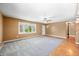 Spacious living room with neutral carpet, large window, and hardwood entryway at 5079 S Lick Creek Rd, Morgantown, IN 46160