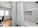 This bathroom has a tub with white subway tiles, a shower niche, and opens to an adjacent bedroom at 5252 N College Ave, Indianapolis, IN 46220