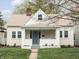 Inviting one-story home featuring a quaint front porch and cheerful curb appeal at 5252 N College Ave, Indianapolis, IN 46220