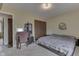 Bedroom with desk, closet, and double bed featuring neutral colors and a carpeted floor at 5335 Honey Comb Ln, Indianapolis, IN 46221