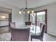 Cozy dining room featuring a round glass table, views of the backyard, and a sliding glass door at 5335 Honey Comb Ln, Indianapolis, IN 46221