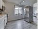 Well-lit kitchen with stainless steel refrigerator, white cabinets, and a view of the dining area at 5335 Honey Comb Ln, Indianapolis, IN 46221
