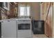Bright laundry room with a washer, dryer, chest freezer, and a small window at 5335 Honey Comb Ln, Indianapolis, IN 46221