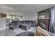 Spacious living area featuring a fireplace, large sectional sofa, and view into the dining room at 5335 Honey Comb Ln, Indianapolis, IN 46221