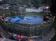 Above ground pool lit with string lights and surrounded by greenery and yard at 5335 Honey Comb Ln, Indianapolis, IN 46221
