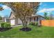 Beautiful home exterior with a blossoming tree, lush green lawn, and a charming front porch at 5622 Imperial Woods Cir, Indianapolis, IN 46224
