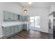 This open kitchen features grey cabinets, stainless steel appliances, and sliding glass doors to the backyard deck at 5622 Imperial Woods Cir, Indianapolis, IN 46224