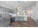 This open concept kitchen features stainless steel appliances, grey cabinets, and new fixtures at 5622 Imperial Woods Cir, Indianapolis, IN 46224