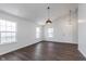 Bright, airy living room with modern lighting, vaulted ceilings, and sleek hardwood floors at 5622 Imperial Woods Cir, Indianapolis, IN 46224
