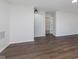 This is a spacious living room featuring wood-look flooring and an entry door at 5622 Imperial Woods Cir, Indianapolis, IN 46224