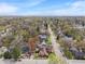 Aerial view of the neighborhood with tree-lined streets and cozy homes in a suburban setting at 5697 Broadway St, Indianapolis, IN 46220