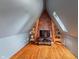 Attic space features a brick accent wall, built-in shelving, and a unique triangular design at 5697 Broadway St, Indianapolis, IN 46220
