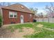 Back exterior of home on a grassy lot with a grill on the patio for Gathering cookouts at 5697 Broadway St, Indianapolis, IN 46220