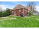 Exterior of home with a grassy backyard. Grill for outdoor gatherings is included at 5697 Broadway St, Indianapolis, IN 46220