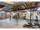 Spacious basement with open ceilings ready for a home gym and featuring the laundry area at 5697 Broadway St, Indianapolis, IN 46220