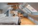 Attic bedroom with wooden floors, spiral staircase, exposed beams, and walk-in closet at 5697 Broadway St, Indianapolis, IN 46220