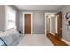 Bedroom with wood floors, gray walls, closet, and ensuite doorway provide a cozy and functional space at 5697 Broadway St, Indianapolis, IN 46220