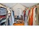 Walk-in closet with clothing racks, shoe rack, and window for natural light at 5697 Broadway St, Indianapolis, IN 46220