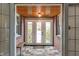 Welcoming entryway featuring tiled floors, wood ceiling and a charming bench at 5697 Broadway St, Indianapolis, IN 46220