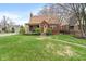 Charming brick home featuring a well-maintained lawn and inviting front porch at 5697 Broadway St, Indianapolis, IN 46220