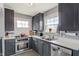 Functional kitchen with stainless steel appliances, white countertops and ample cabinet space at 5697 Broadway St, Indianapolis, IN 46220