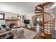 Open living room featuring a cozy fireplace and a unique spiral staircase at 5697 Broadway St, Indianapolis, IN 46220