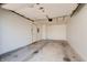 Empty garage with concrete floor, garage door opener and door to house at 5839 Quail Run Dr, Indianapolis, IN 46237