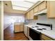 Open-concept kitchen with modern appliances, abundant cabinet storage, and hardwood floors at 5839 Quail Run Dr, Indianapolis, IN 46237