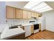 Well-lit kitchen featuring modern appliances, ample counter space, and light wood cabinetry at 5839 Quail Run Dr, Indianapolis, IN 46237