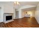 A spacious living room featuring a fireplace, ceiling fan and open view to kitchen at 5839 Quail Run Dr, Indianapolis, IN 46237