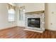 A cozy living room featuring a stone fireplace and large windows for natural lighting at 5839 Quail Run Dr, Indianapolis, IN 46237