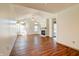 Spacious living room featuring hardwood floors, a fireplace, arched windows, and a vaulted ceiling at 5839 Quail Run Dr, Indianapolis, IN 46237
