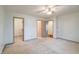 Spacious main bedroom featuring neutral carpet and ceiling fan with attached closet and bathrooms at 5839 Quail Run Dr, Indianapolis, IN 46237