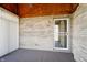 A covered outdoor patio with brick wall, a fan, and outdoor carpet at 5839 Quail Run Dr, Indianapolis, IN 46237