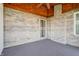A covered outdoor patio with brick wall, a fan, and outdoor carpet at 5839 Quail Run Dr, Indianapolis, IN 46237