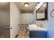 This bathroom features a single sink vanity, shower with curtain, and light tile flooring at 598 Collier St, Columbus, IN 47201