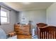 Bright Bedroom room features a crib, dresser with changing table, and natural light at 598 Collier St, Columbus, IN 47201