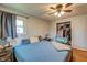 Bedroom with wood floors, a ceiling fan, and closet space at 598 Collier St, Columbus, IN 47201