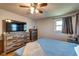 Bedroom featuring wood floors, a ceiling fan, and a dresser with a TV at 598 Collier St, Columbus, IN 47201